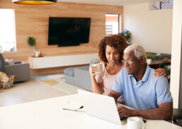 Senior,African,American,Couple,Using,Laptop,To,Check,Finances,At